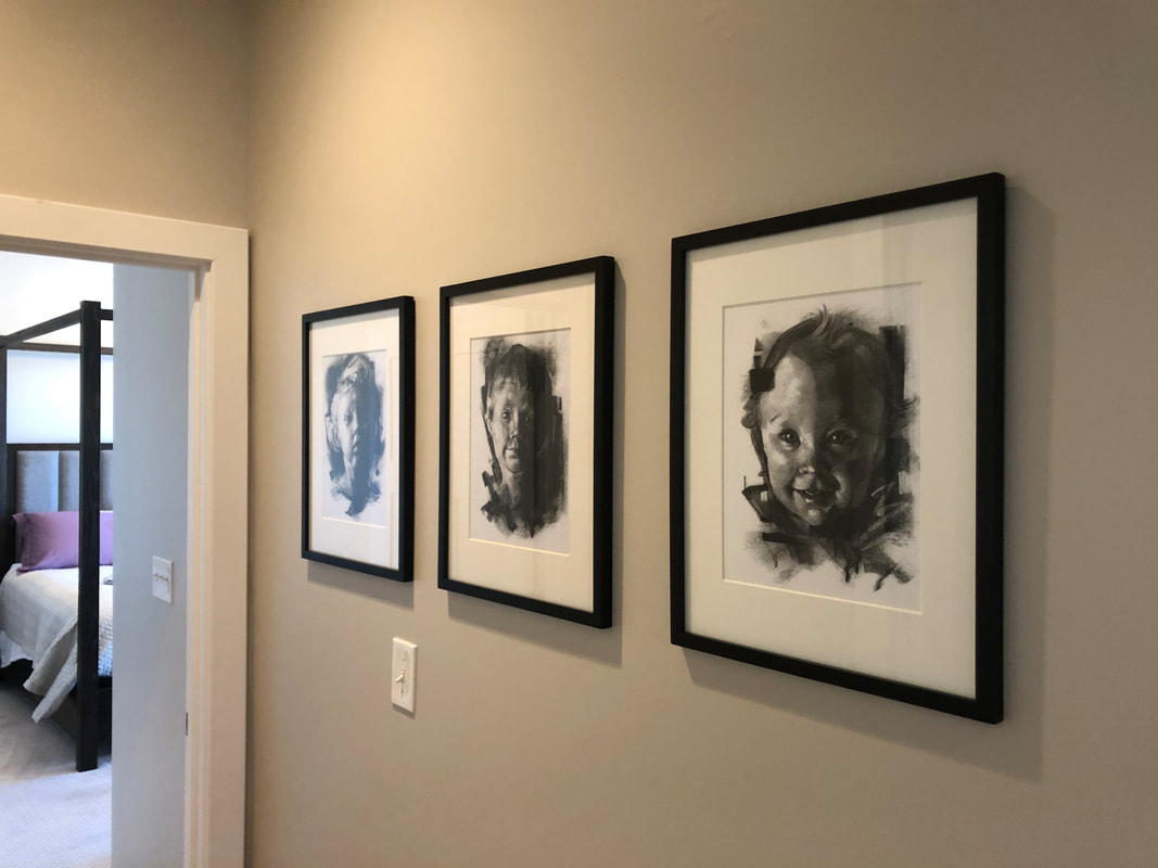 Charcoal Portraits by James Thomas framed in house